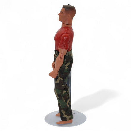 Back view of marine action figure showing red shirt and camo pants