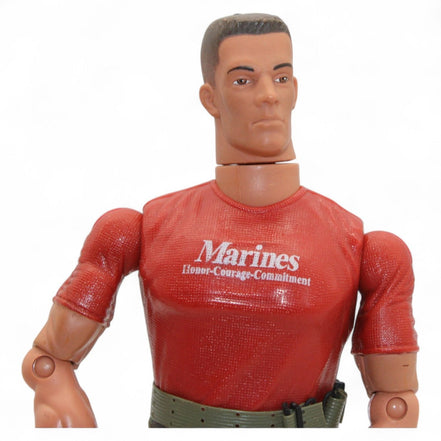 Marine action figure wearing a red shirt with 'Marines Honor Courage Commitment' and camouflage pants