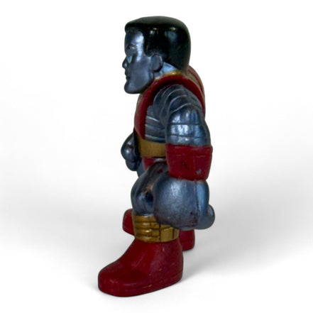 Side view of Colossus figure showing detailed armor
