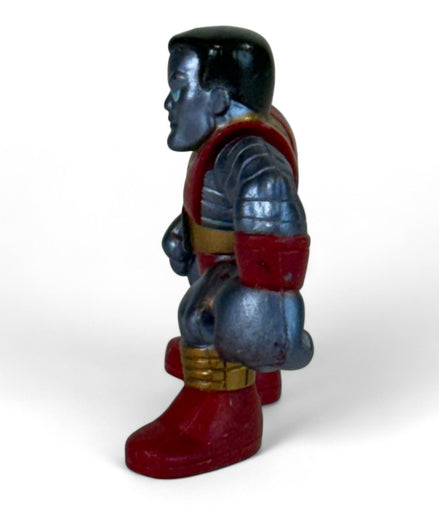 Side view of Colossus figure showing detailed armor