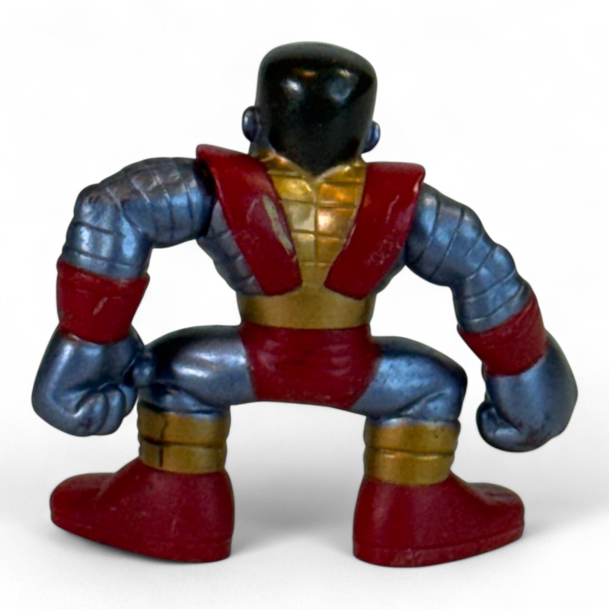 Back view of Colossus figure with red and gold details