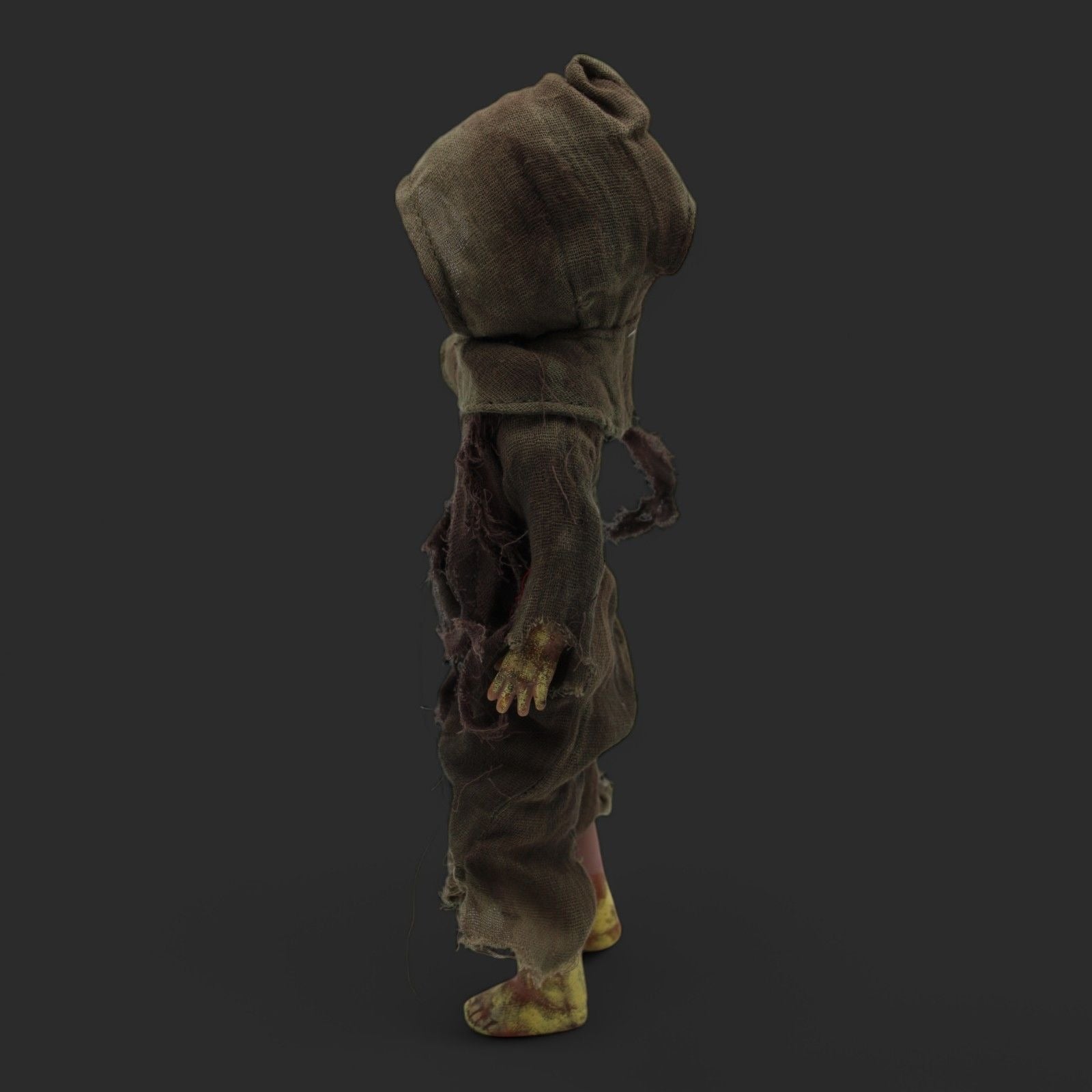Back view of Menard Zombie Doll highlighting the hooded cloak