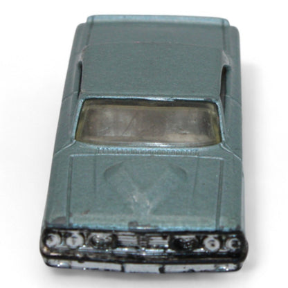 Vintage diecast model of a blue Chevy Impala, featuring chrome accents, black interior, and classic 1960s styling with minor play wear.
