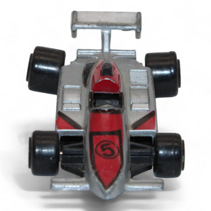 A silver and red diecast formula‑style race car toy with number 5 livery, vintage 1:64 scale metal model in fair play condition.
