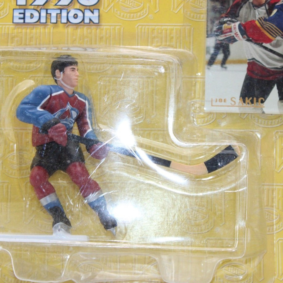 A mint 1996 Kenner Starting Lineup Joe Sakic action figure in Colorado Avalanche jersey, unopened with original hockey card, collectible.
