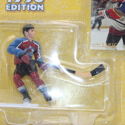 A mint 1996 Kenner Starting Lineup Joe Sakic action figure in Colorado Avalanche jersey, unopened with original hockey card, collectible.

