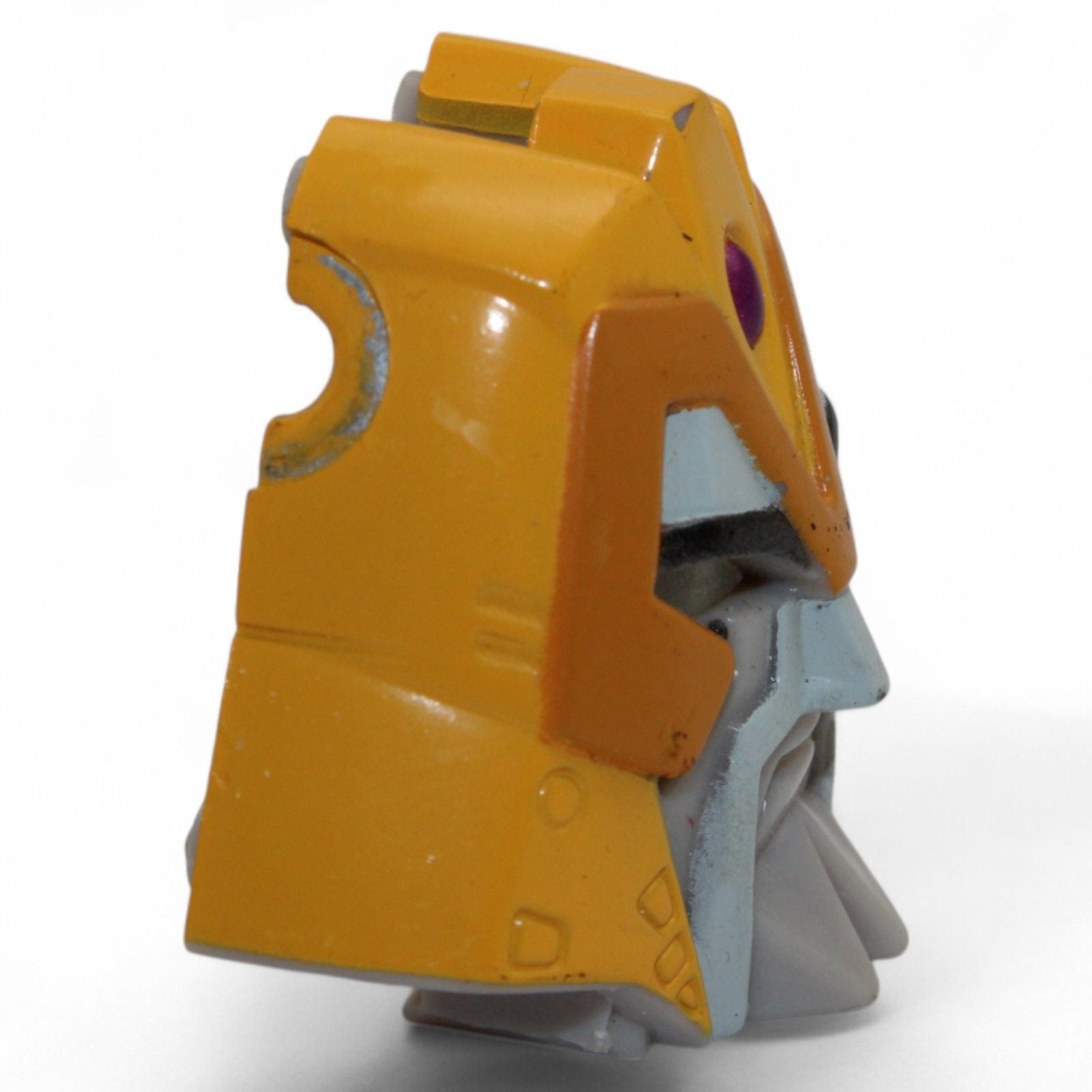 Side view of Transformers Armada Unicron face piece, yellow and gray