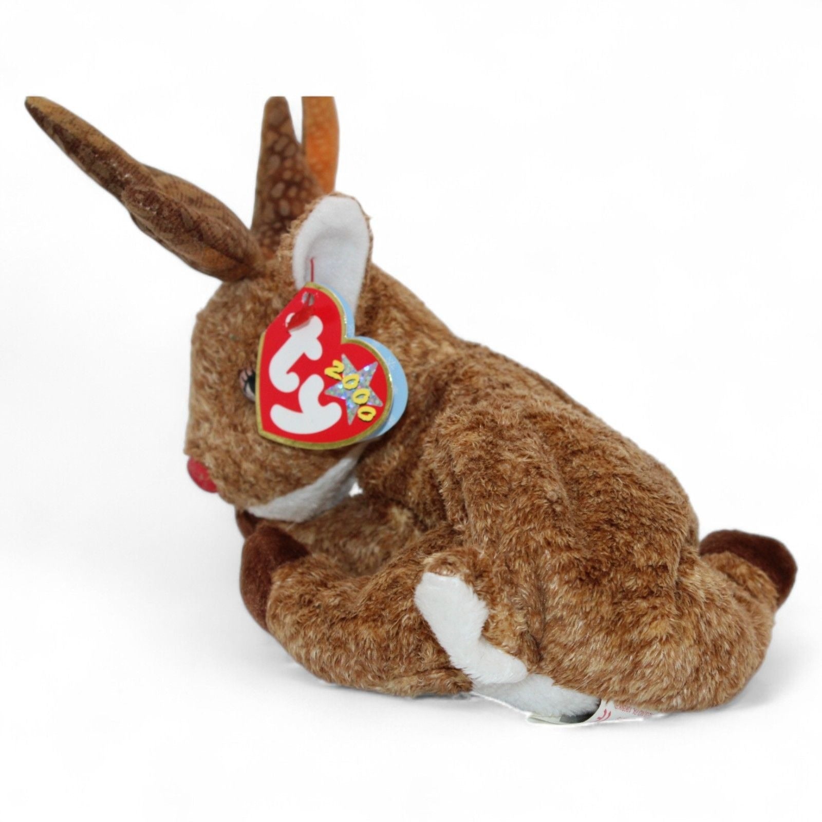 Side view of Ty Beanie Baby Roxie The Reindeer plush toy showing red nose and tags