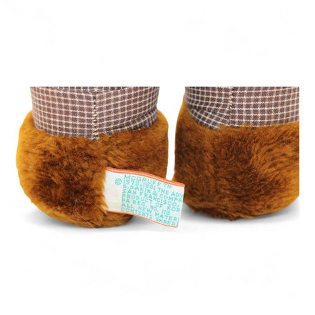 Close-up of McGruff plush feet with tag