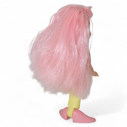 Vintage mermaid doll with pink hair and yellow tail, side profile