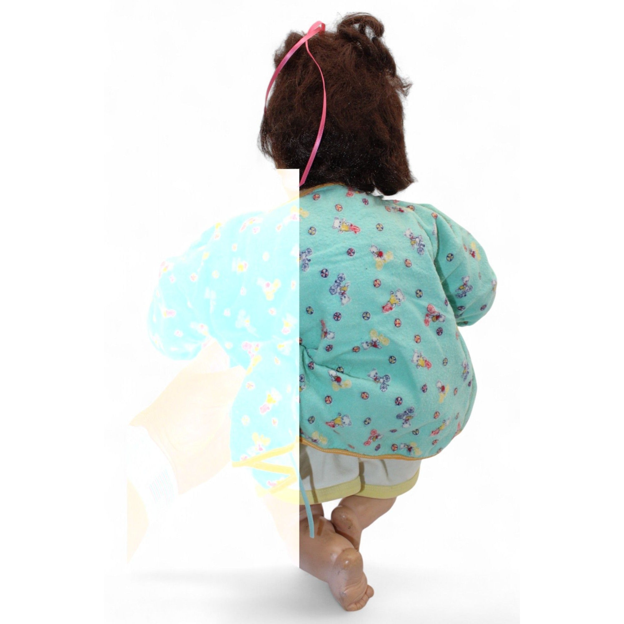 Back view of the vintage doll's green floral jacket.