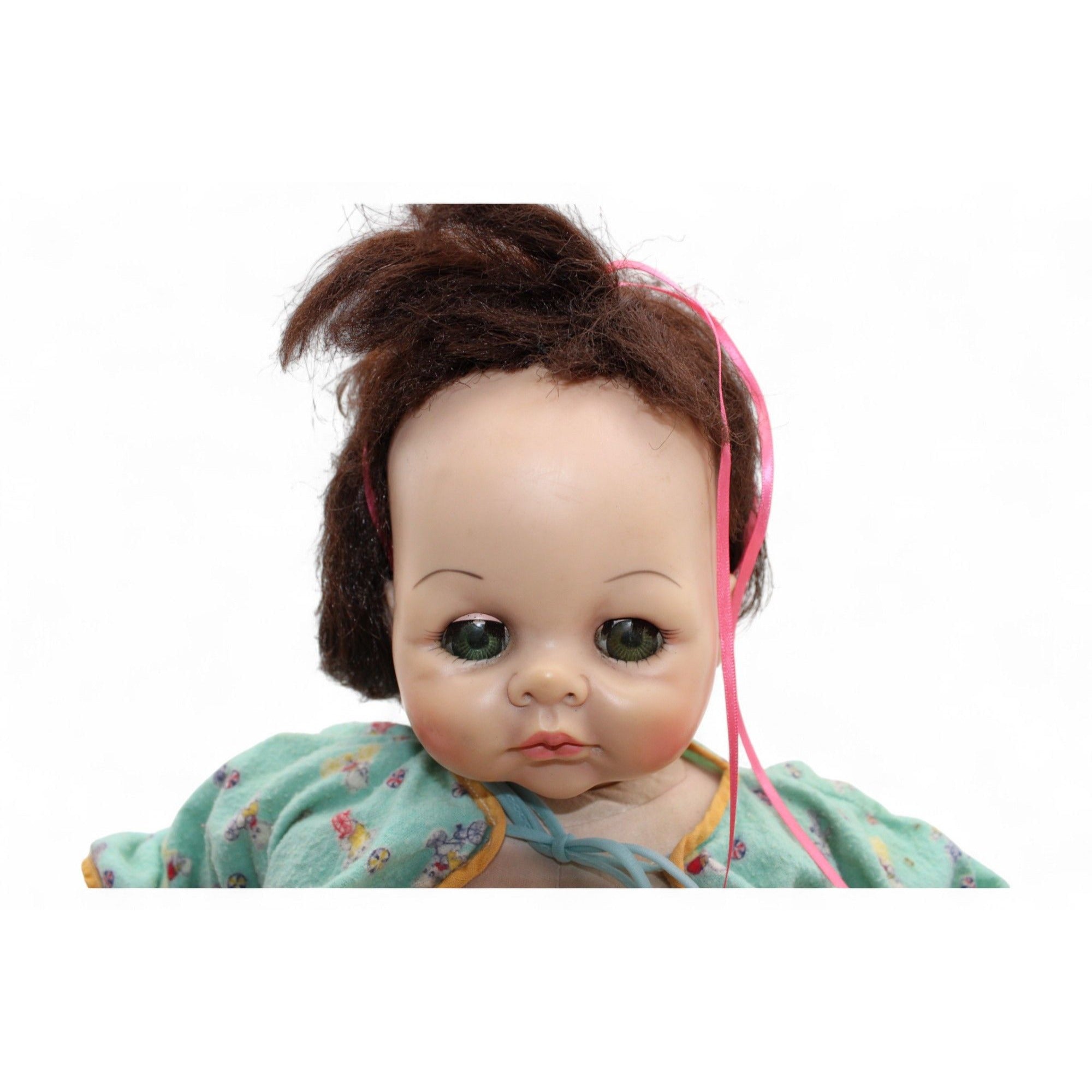 Detailed view of the vintage doll's hand and arm with vinyl material.