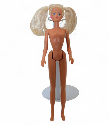 Vintage Barbie doll with blonde pigtails and pink earrings