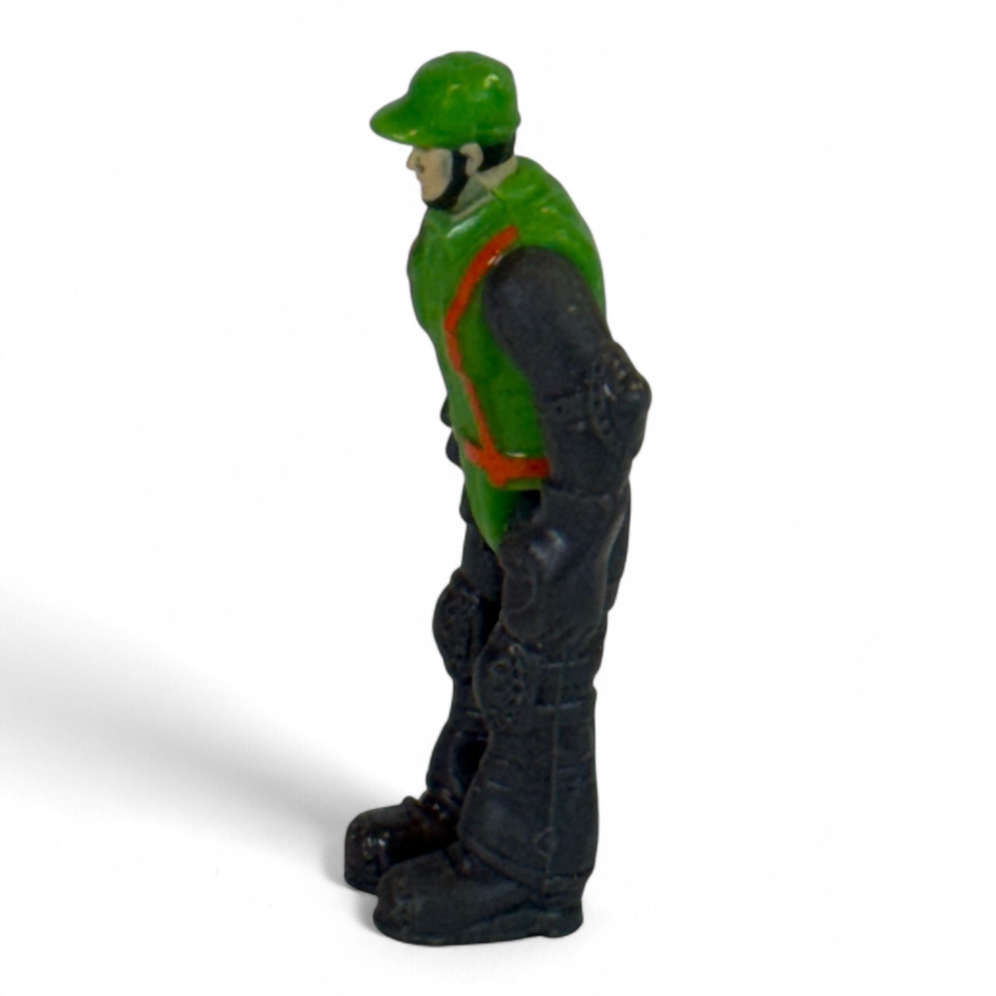 Side view of vintage green and black toy soldier action figure
