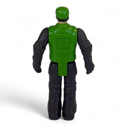 Back view of vintage green and black toy soldier action figure