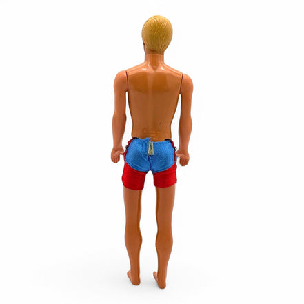 Profile of vintage Ken doll with molded hair
