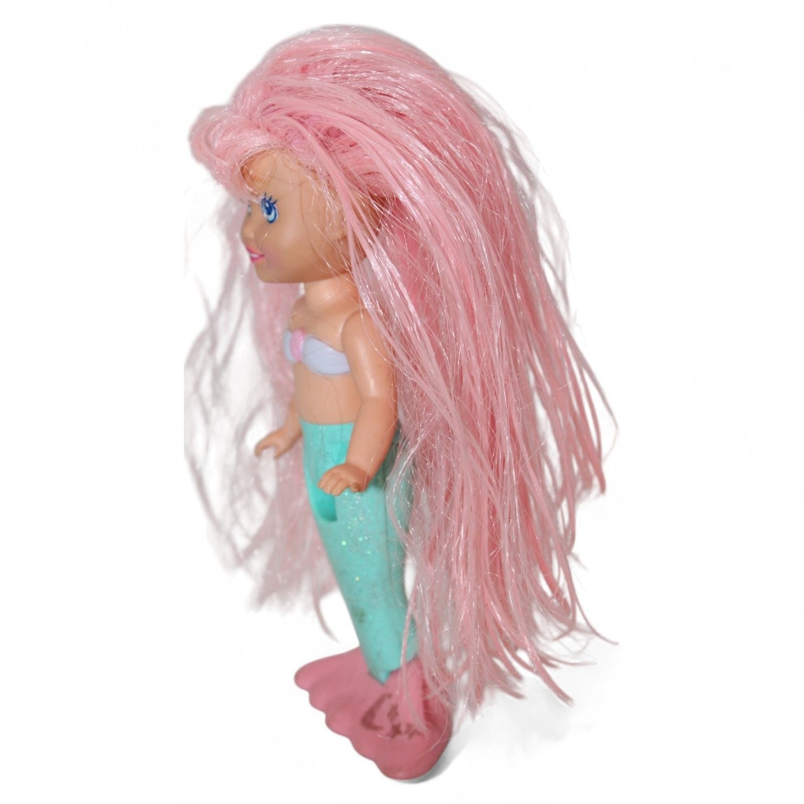 Side view of vintage mermaid doll with pink hair