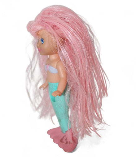 Side view of vintage mermaid doll with pink hair