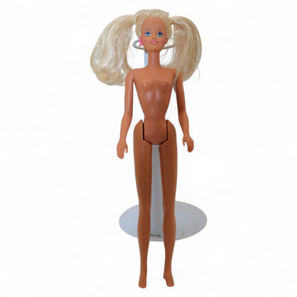 Vintage Mattel Ponytail Barbie #4 doll from 1960 with rooted blonde hair, hard plastic body, and iconic facial paint, in used condition.
