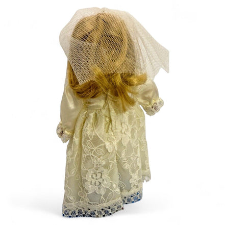 Back view of vintage porcelain bride doll with lace dress and veil