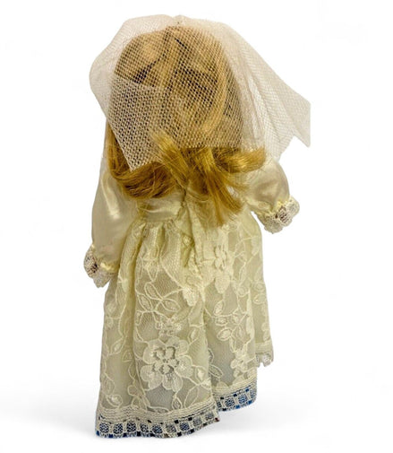 Back view of vintage porcelain bride doll with lace dress and veil