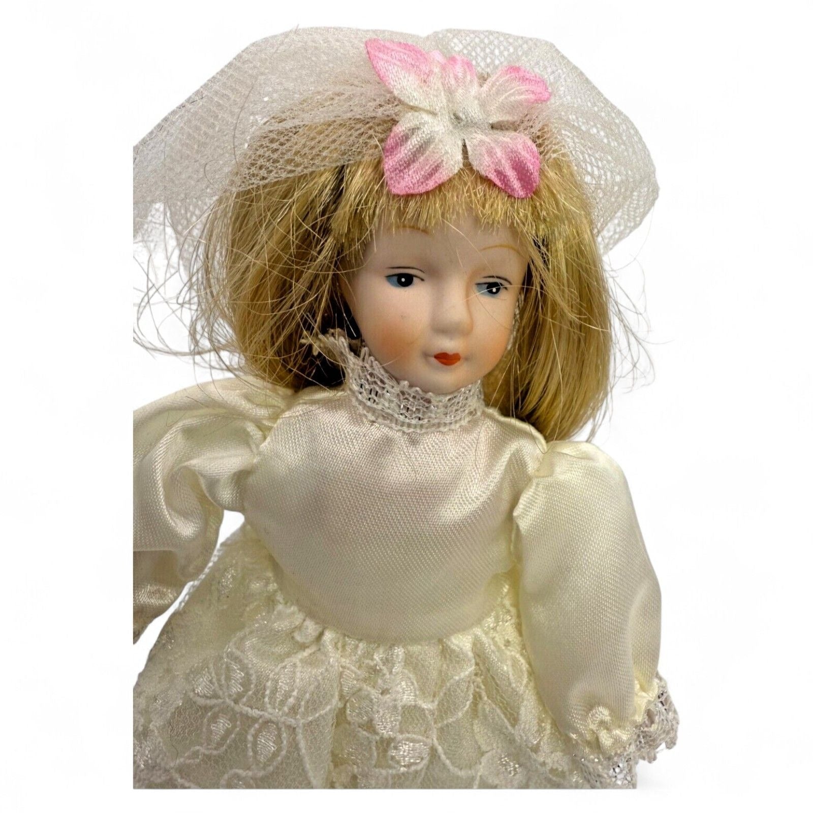 Vintage porcelain bride doll with lace dress and veil, front view