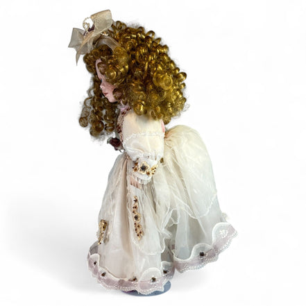 Side view of vintage porcelain doll in lace dress