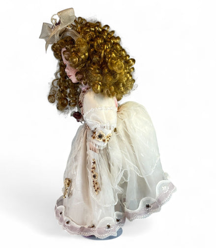 Side view of vintage porcelain doll in lace dress