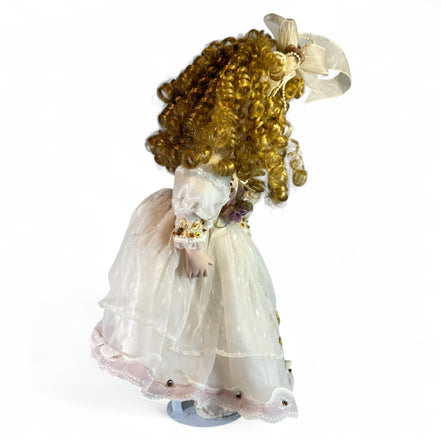 Detailed view of lace and beaded dress on porcelain doll