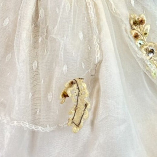 Vintage porcelain doll with blonde curly hair and Victorian dress