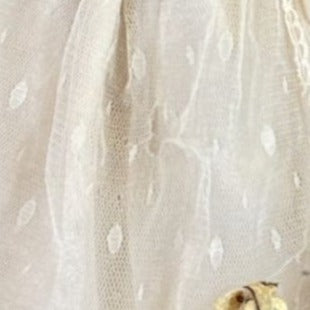 Vintage porcelain doll with blonde curly hair and Victorian dress