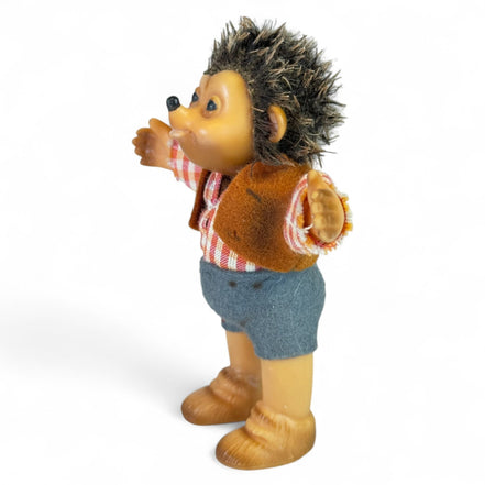 Side view of vintage Steiff hedgehog toy in plaid shirt