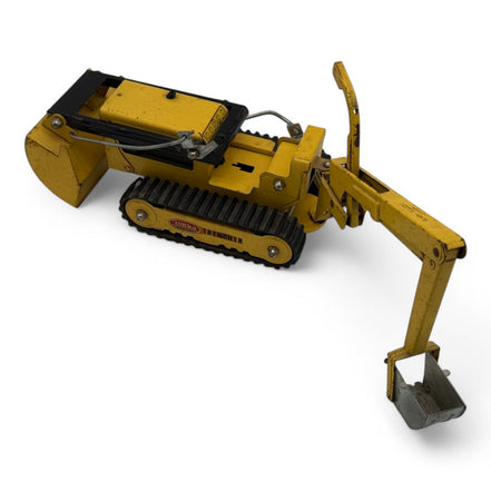 Side view of Tonka Trencher toy showing excavator arm and tracks
