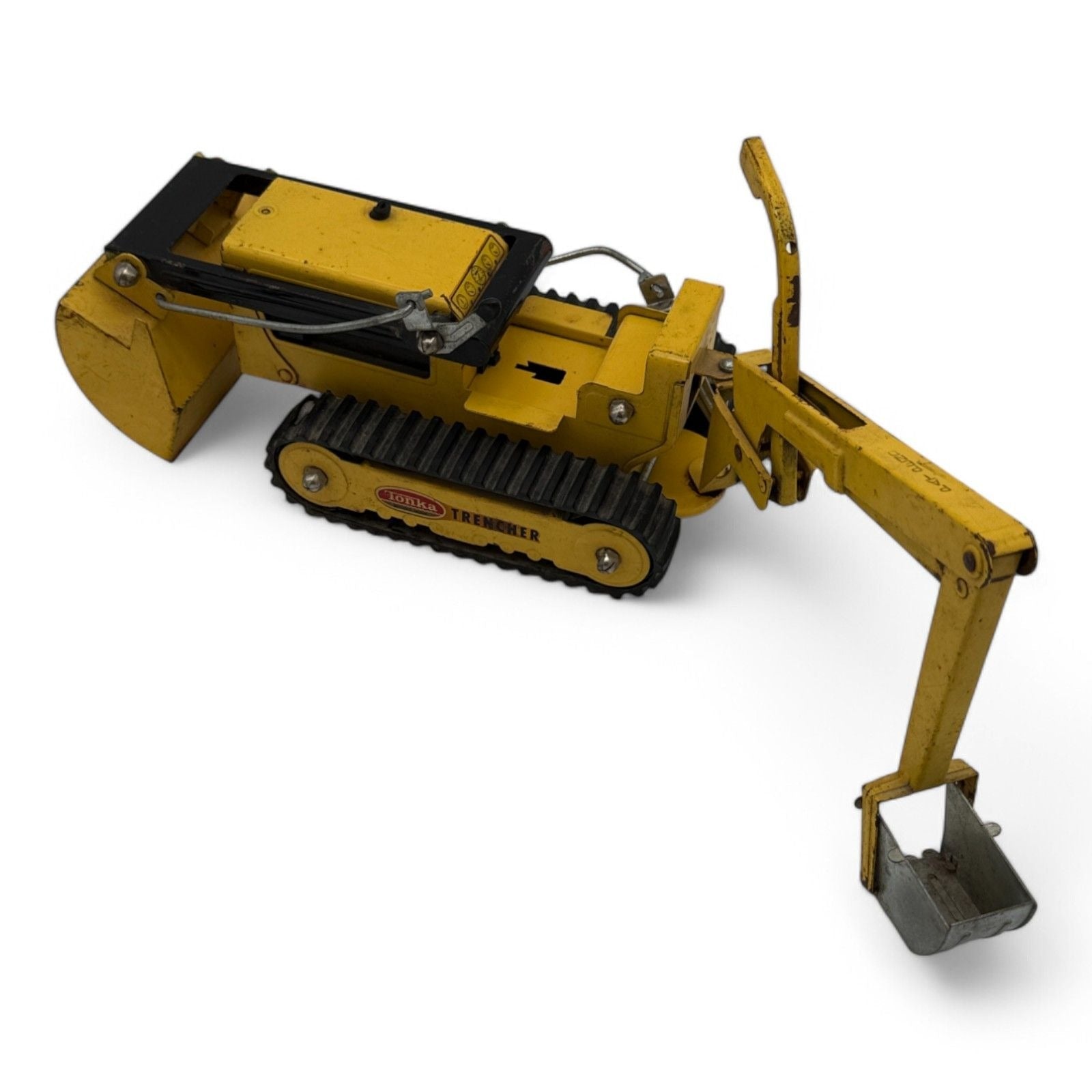 Side view of Tonka Trencher toy showing excavator arm and tracks