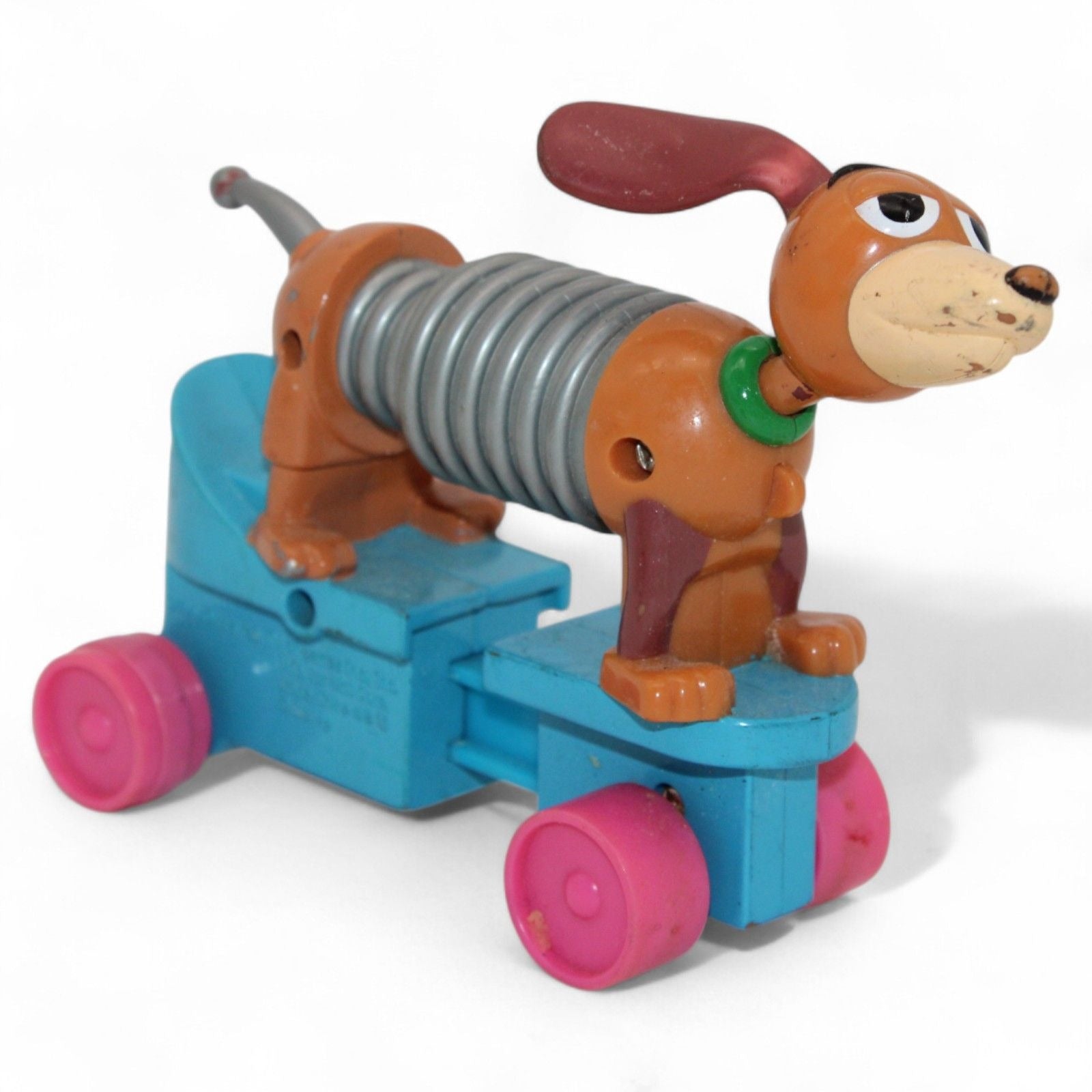 Vintage Toy Story Slinky Dog with pink wheels and flexible body