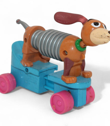 Vintage Toy Story Slinky Dog with pink wheels and flexible body