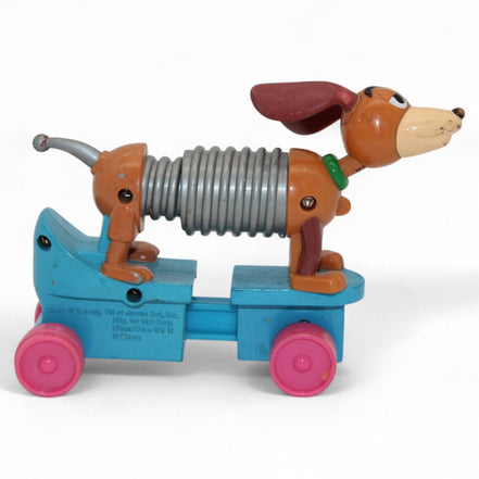 Vintage Toy Story Slinky Dog with pink wheels and flexible body