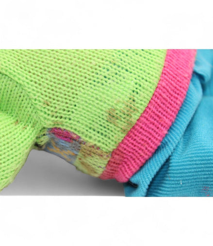 Close-up of colorful knitted outfit on vintage troll doll