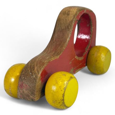 Handmade wooden car with red body and yellow wheels