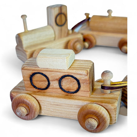 Vintage wooden toy train set with engine and four cars made from natural wood