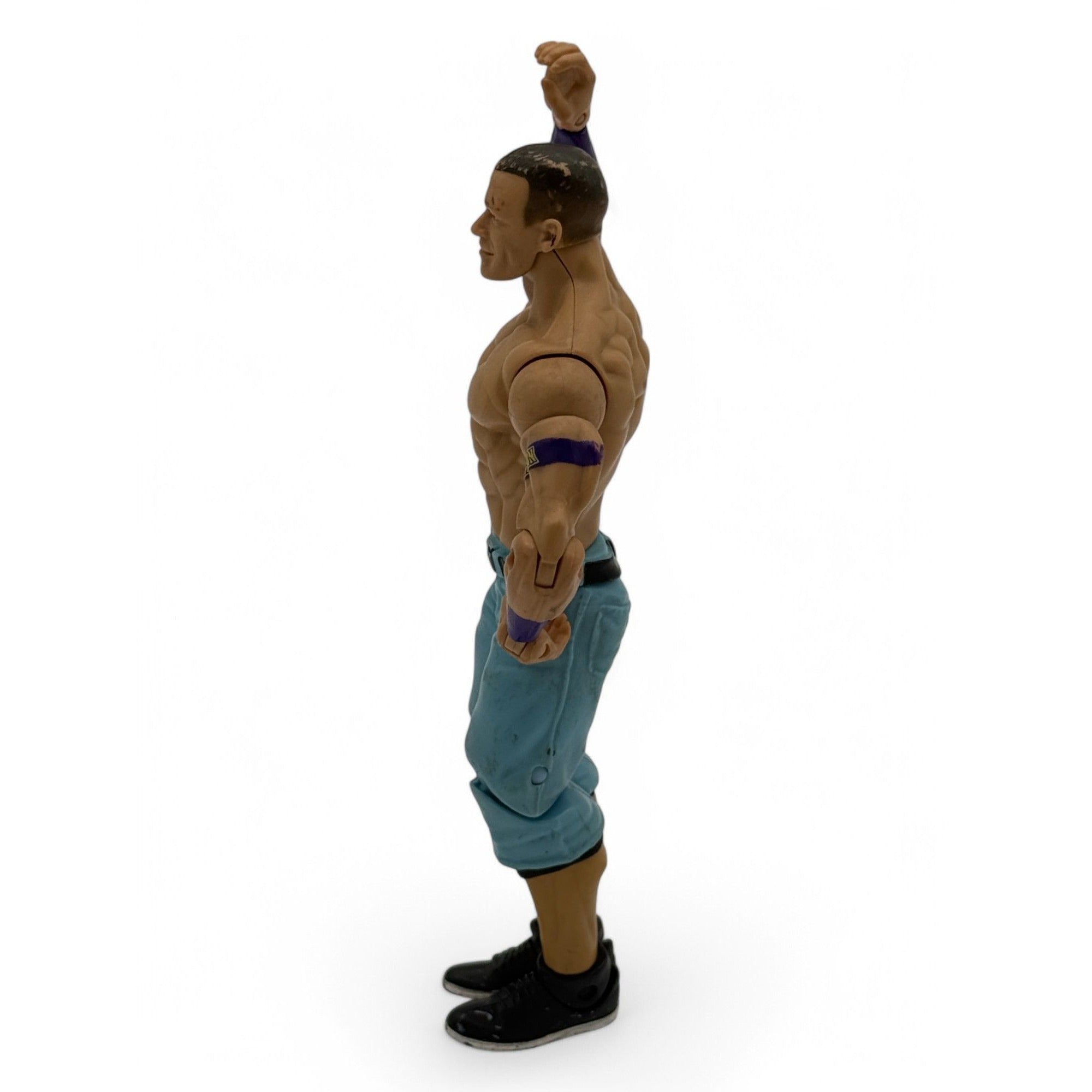 Side view of WWE John Cena action figure showing poseable arms